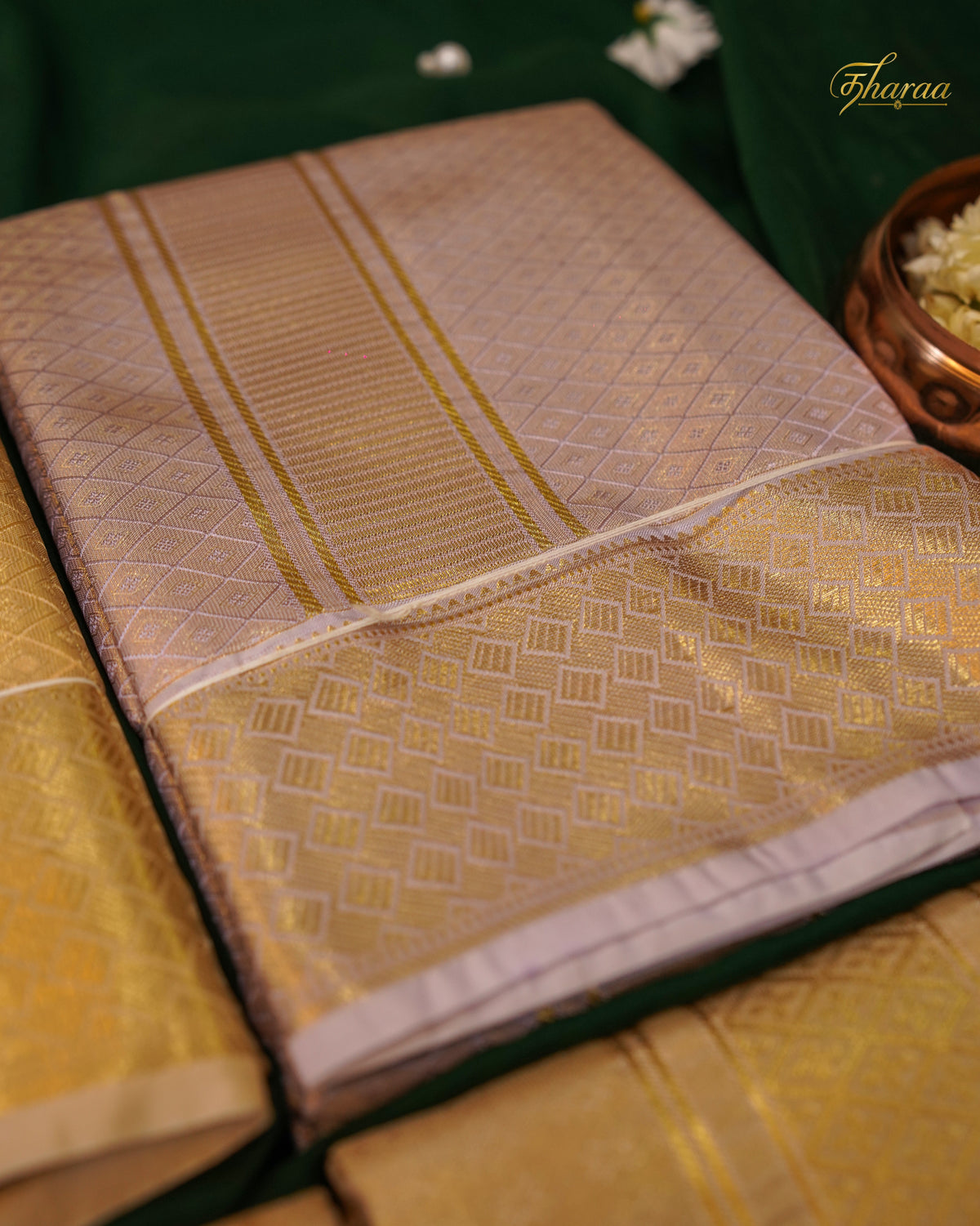 HEMAVARMAN dhoti is crafted from semi-silk fabric with a gold border and embossed design, combining durability and traditional aesthetics. Its semi-silk composition provides a balanced texture and sheen, suitable for formal occasions. The gold border enhances visual appeal while maintaining structural